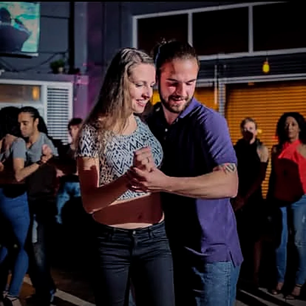 James dancing with a smiling partner at a social event